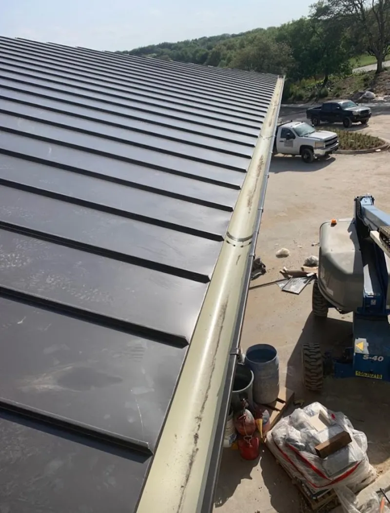 Standing seam panel and gutter detail on a metal roofing jobsite in The Hammocks